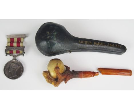 An Indian Mutiny Medal to Ens. A. Bailey38th Regt. with Lucknow clasp, together with his meerschaum pipe, in Morocco leather 