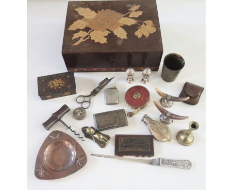 A marquetry box containing assorted collectables including horn knife rests, bezique marker, papier mache box, tape measure, 