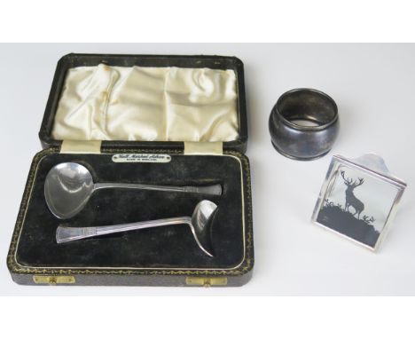 A mixed collection of silver wares including two-piece christening set, napkin ring and name place holder, weighable silver 4