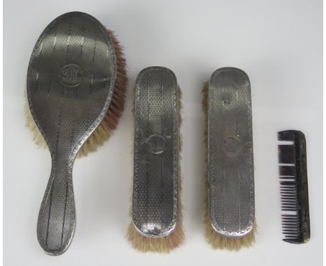 A matched four-piece silver backed dressing table set, maker Horton &amp; Allday, Birmingham, 1920, 25, monogrammed, with eng