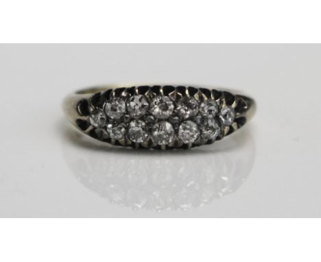 An Antique Old and Rose Cut Diamond Two Row Ring in a high carat precious yellow metal setting, c. 2.55mm principal stones, s