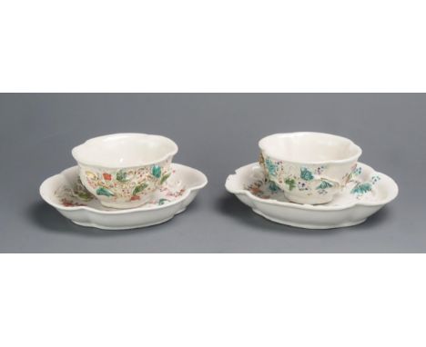 A pair of Chinese export porcelain tea bowls and saucers with raised foliate decoration. 