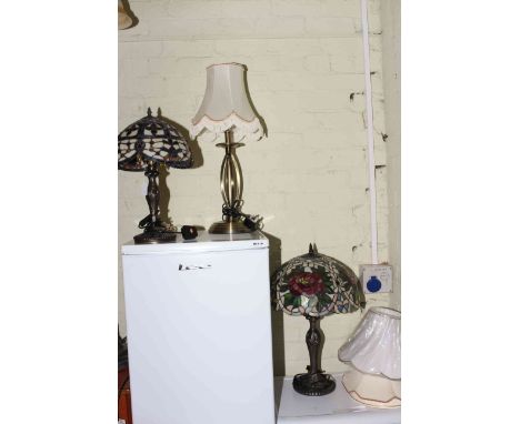 Two Tiffany style table lamps, metal table lamp and four shades