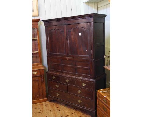 Georgian oak press having two arched panel doors above a fall front with six drawers below on bracket feet, 130.5cm by 193cm