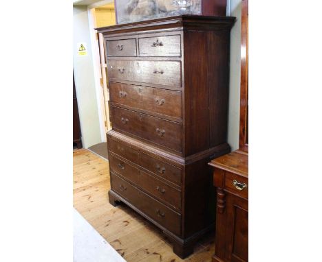 Georgian oak chest on chest, the top having two short and three long drawers above abase of three long drawers on bracket fee