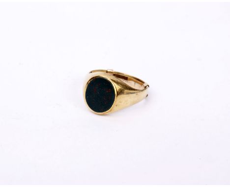 A 9ct gold gents signet ring set with oval bloodstone panel. 7.7g Size S(fitted with 9ct sizing bar)