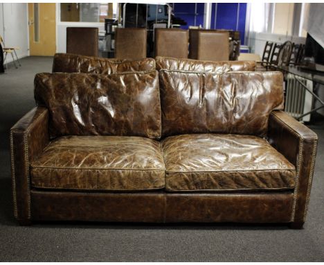 Two seater modern  square arm leather sofa in chocolate, studs to front arms. Dimensions 81cm(L) x 70cm(D) x 79cm(H)