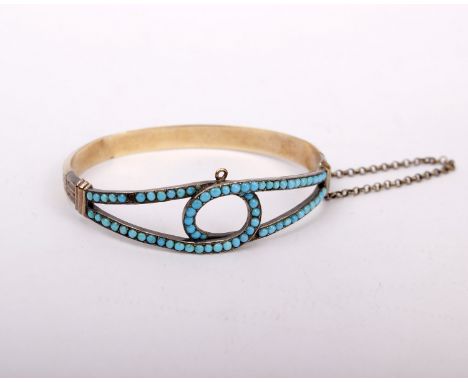 An unmarked white and yellow metal Victorian bangle bracelet set with cabochon turquoise (one vacant. In fitted red leather b