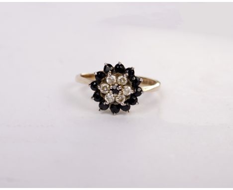 A 9ct gold sapphire and diamond flower ring. Six single cut diamond with a surround of round single cut sapphires. Size O. 2.