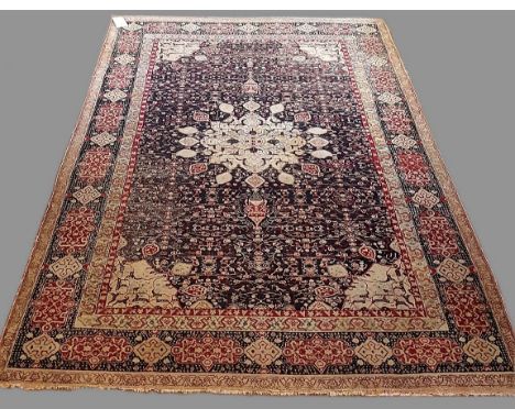 AGRA CARPET Central/North India, the charcoal lattice field with central flowerhead medallion framed by spandrels and cartouc