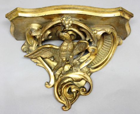 GILT GESSO WALL BRACKET, the serpentine shelf above an eagle amongst scrolling foliage, height 40cm, width 52cm