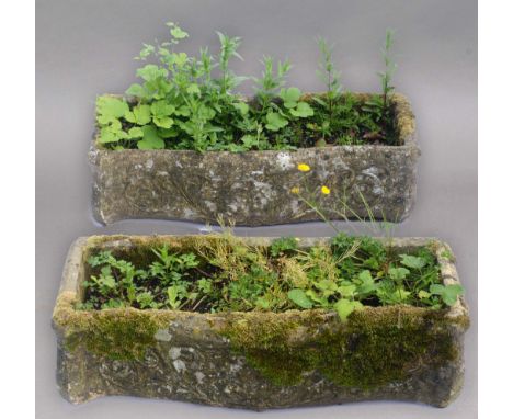 PAIR OF RECONSTITUTED STONE TROUGH PLANTERS, of serpentine form with scrolling decoration, height 20cm, width 78cm, depth 32c