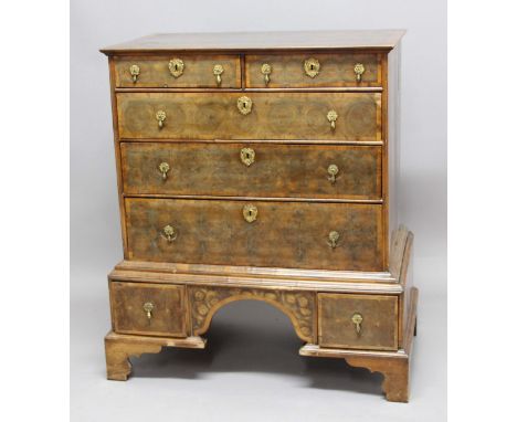 WILLIAM AND MARY WALNUT OYSTER VENEERED CHEST ON STAND, with two short and three graduated long drawers on a stand with two d