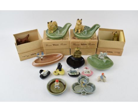 A collection of Wade and Irish Wade pottery to include pen holders, pipe rests, ashtrays and pin dishes to include dogs, lepr