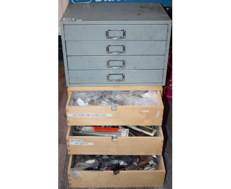 Two sets of drawers containing watch and lock parts to include NOS watch straps and bracelets, ceramic clock dials, vintage w