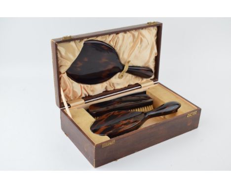 Vintage tortoiseshell vanity set to include, brush, mirror, comb and flat brush in leather case with satin liner.  In good or