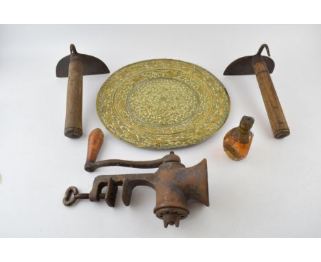 Two antique wrought iron pig scrapers / butchers tools together with a mincer and a brass charger and a miniature bottle of D