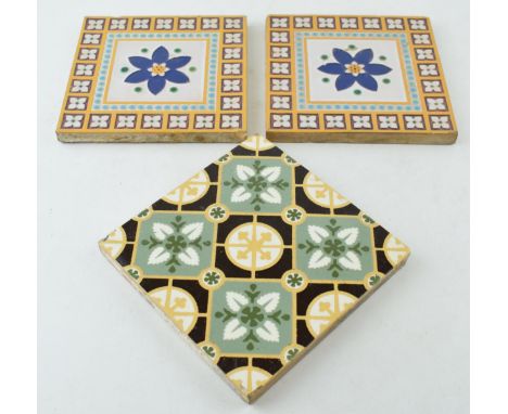 Two 6" Minton &amp; Co, Stoke on Trent glazed tiles with central blue floral design and repeated boarder design in turquoise 