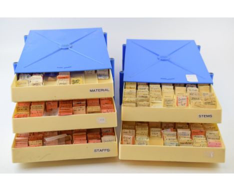 Two plastic trays full of watch stems and staffs for manufacturers such as Kienzle, Citizen, Zenith, Omega, Cyma and similar 