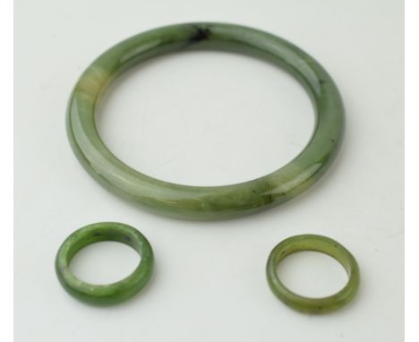 Two jade rings sizes O and P together with a jade bangle. (3) Weight 42.8 grams.  In good original vintage condition. Jade or