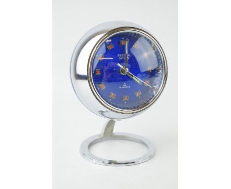 A Presta Saturn 2 jewels Chrome vintage clock c1970s. Round blue metalic dial with orange applied baton markers. Alarm functi
