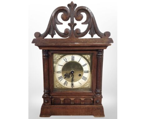 A late Victorian carved oak mantel clock case with later battery movement, height 42cm.