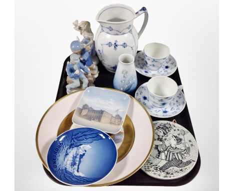 A group of Danish porcelain figures, Royal Copenhagen blue and white jug and similar cup and saucers, Bing and Grøndahl flora