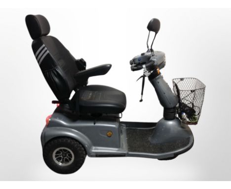 A Karma mobility scooter with key and charger. CONDITION REPORT: When turned on, the scooter's lights flash continuously and 