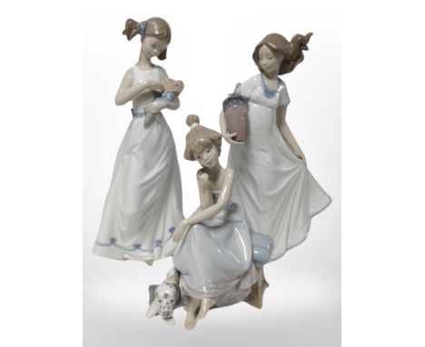 A Lladró figure of a girl and a dog, No. 5466, and two Nao figures of girls.