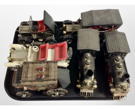 A group of model locomotives and vintage cars.