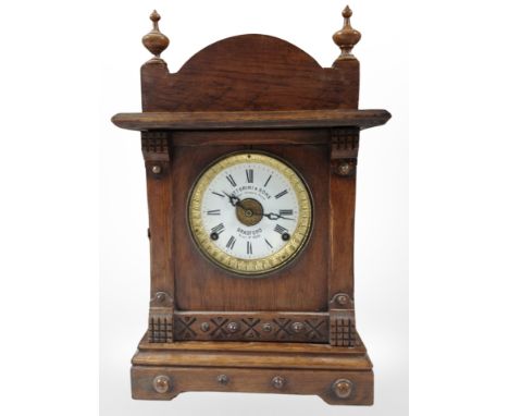 An oak-cased eight-day mantel clock retailed by Fattorini & Sons of Bradford, height 43cm.