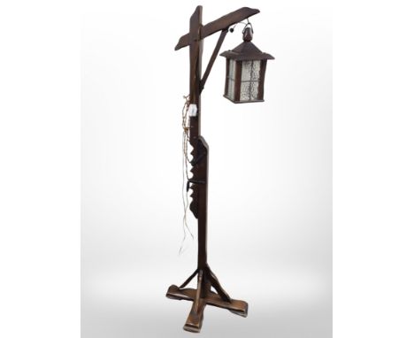 An oak standard lamp with lantern shade, height 148cm.
