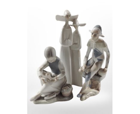 A Lladró figure of two nuns, No. 4611, together with a Nao bisque porcelain figure, and a further Spanish figure of a Harlequ