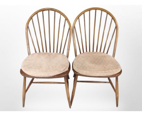 A pair of Ercol stained elm spindle-back dining chairs.