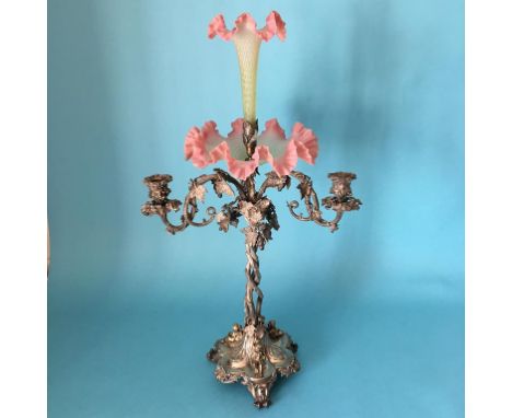 A tall and impressive silver plated and glass epergne, with central glass trumpet and bowl, below three candle sconces, suppo