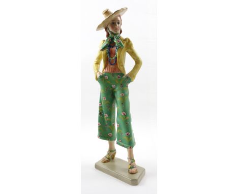 A c1930 Lenci figure of a girl in culottes, a wide brim straw hat and scarf with yellow jacket, height 46cm. CONDITION REPORT