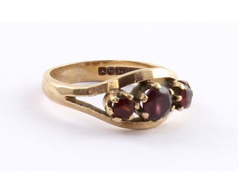 A 9ct gold ladies' dress ring set with three garnets, size N1/2, approx 3.6g.