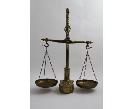 A set of vintage c1910 brass balance scales with swan head hanger and reeded column above a cast brass base with weight compa