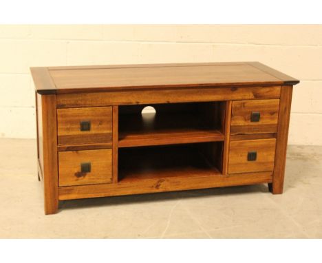 A modern teak side table with twin shelf compartments flanked by twin drawers, 55 x 45 x 115cm.