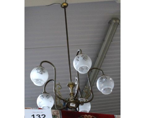 A vintage brass five-branch candelabrum with opaque etched glass shades, length 122cm.