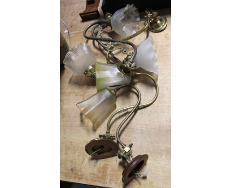 A pair of vintage brass ornate wall lights with ribbed opaque glass tulip shape shades, a pair of brass wall lights with yell