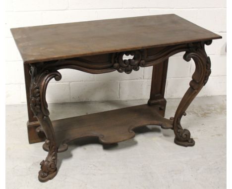 A 20th century oak console table carved frieze to carved cabriole front supports and lower shelf, length 113cm. CONDITION REP