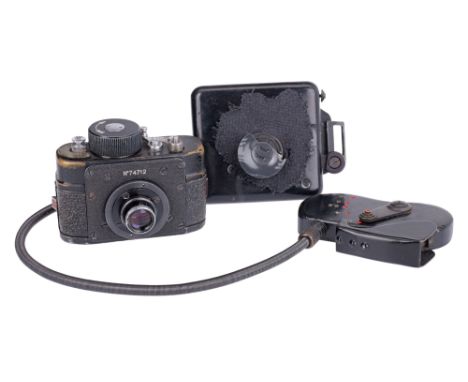 black, serial no. 74712, body G, shutter working, clockwork mechanism winds, together with coat button shutter housing, worki