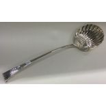 A large 18th Century silver Onslow pattern soup ladle of fluted design.