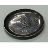 A Chinese export silver coin dish chased with figure to centre.