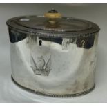 An 18th Century George III silver tea caddy with crested dragon to centre.