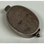 A good novelty oval silver box in the form of a mask with spring mount to gilt interior.