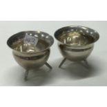 A rare pair of Victorian silver cauldron shaped salts on three feet.