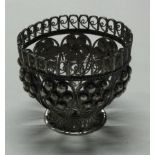 A filigree silver egg cup.
