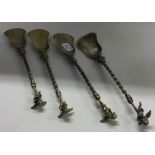 A set of four silver figural ice cream spoons.